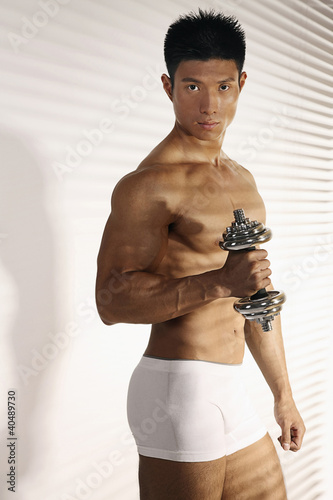 Photo: Man lifting dumbbell Man lifting dumbbell