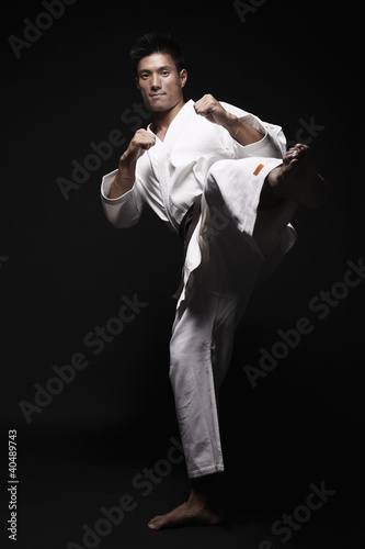 Photo: Man performing karate move Man performing karate move