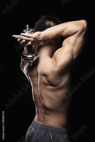 Photo: Muscular man lifting dumbbell Muscular man lifting dumbbell