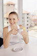 Photo: Woman smiling and holding a cup of lemon tea Woman smiling and holding a cup of lemon tea