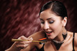 Woman eating sushi