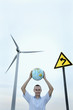 Man holding globe above his head, smiling