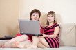 Girl sitting on sofa with laptop Girl sitting on sofa with laptop