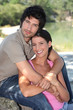 Couple embracing in front of pond