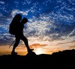hiker silhouette on a sunset background