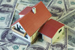 Two-story toy house with on hundred dollar notes.