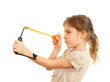 Concentrated girl with slingshot aim isolated on white