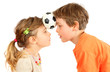 Brother and sister hold their heads little ball