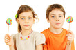 Brother and sister hold colorful lollipops isolated on white