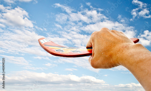 Photo: hand holdiing boomerang with blue sky hand holdiing boomerang with blue sky