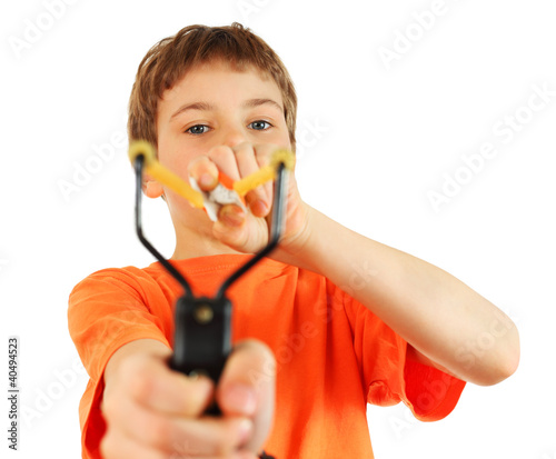 Photo: Boy wearing in orange t-shirt with slingshot aim to camera Boy wearing in orange t-shirt with slingshot aim to camera