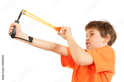 Photo: Concentrated boy with slingshot aim isolated on white background Concentrated boy with slingshot aim isolated on white background