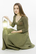 The girl with a lantern sits on a white background