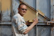 Man painting gate  Ukraine