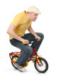 canvas print picture - Cool guy goes on a children's bicycle on white