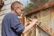 Man painting gate  Ukraine