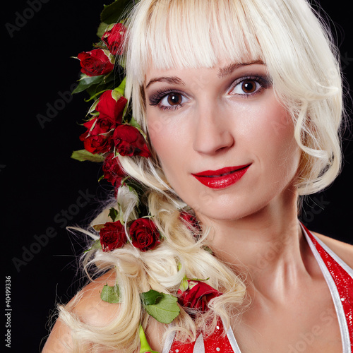 Photo: Portrait of a young woman with roses in hair Portrait of a young woman with roses in hair