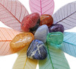 Chakra stones on skeleton leaves, close up