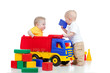 two little children playing with color toys