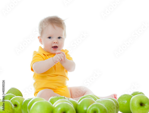 Photo: Adorable child with green apples Adorable child with green apples
