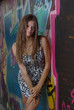 Slim girl against graffiti wall Slim girl against graffiti wall