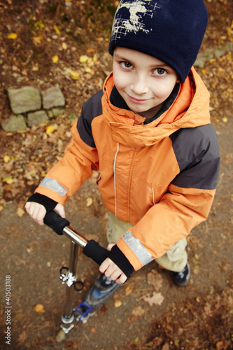 Photo: Boy driving a scooter Boy driving a scooter