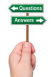 Hand holding road sign with directions Questions Answers.