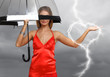 Pretty young woman with umbrella and hearts
