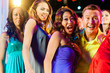 Party people dancing in disco or club
