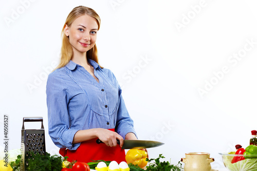 Photo: Woman cooking fresh meal at home Woman cooking fresh meal at home