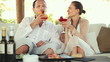 Young happy couple talking and drinking exotic cocktails