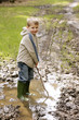 Boy in mud puddle