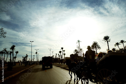 Photo: People riding in horse-drawn carriage People riding in horse-drawn carriage
