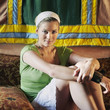 Woman sitting on the couch staring at the camera