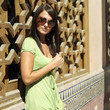 Woman in trendy sunglasses smiling at the camera