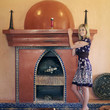 Woman posing at the fireplace