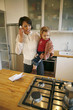 Mother carrying daughter while talking on the phone