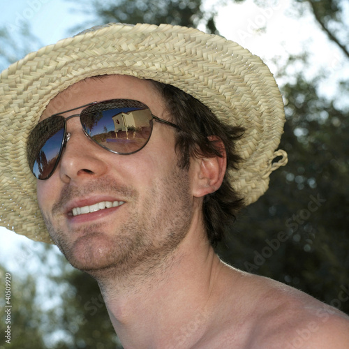 Photo: Man in straw hat and sunglasses smiling Man in straw hat and sunglasses smiling