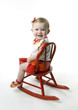 Girl sitting on rocking chair