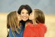Girls kissing mother