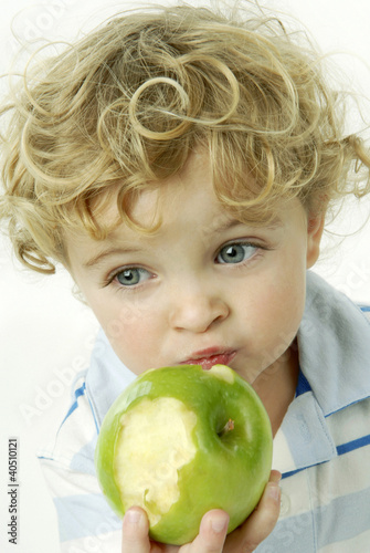 Photo: Boy eating green apple Boy eating green apple