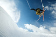 Man doing a mid air ski jump off a mountain 
