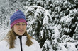 Woman wearing knit hat and winter clothing standing outdoor