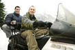 Two men riding on snowmobile