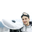 Man in warm clothing holding ski board