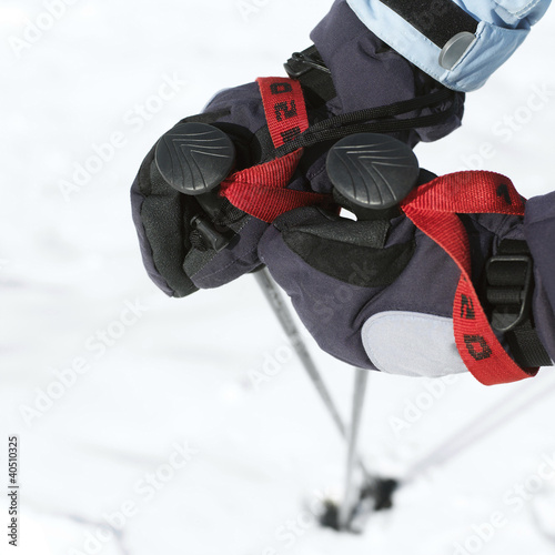 Photo: Hand in gloves holding ski poles Hand in gloves holding ski poles