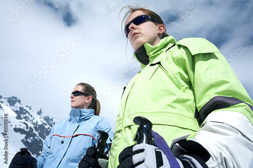 Photo: Two women getting ready for snow skiing Two women getting ready for snow skiing