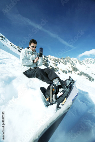 Photo: Male snowboarder adjusting his glove Male snowboarder adjusting his glove