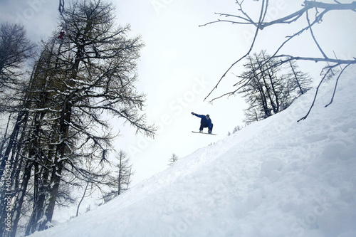 Photo: Man jumping in mid air on snowboard Man jumping in mid air on snowboard