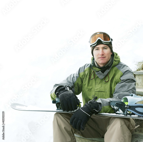 Photo: Man posing with his snowboard Man posing with his snowboard